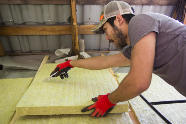 Efficiency worker insulating a home