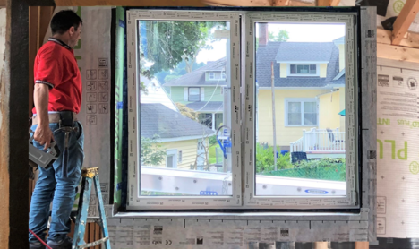 Energy Efficiency workers perform air-sealing and install windows, insulation